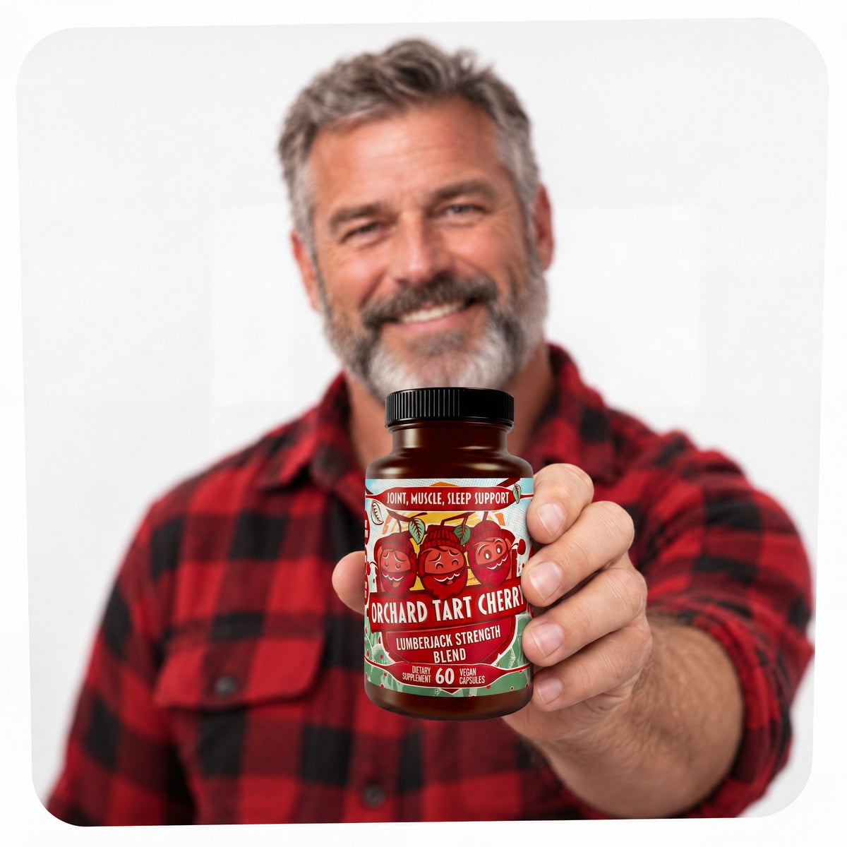 Smiling lumberjack holding out a bottle of Orchard Tart Cherry toward the camera