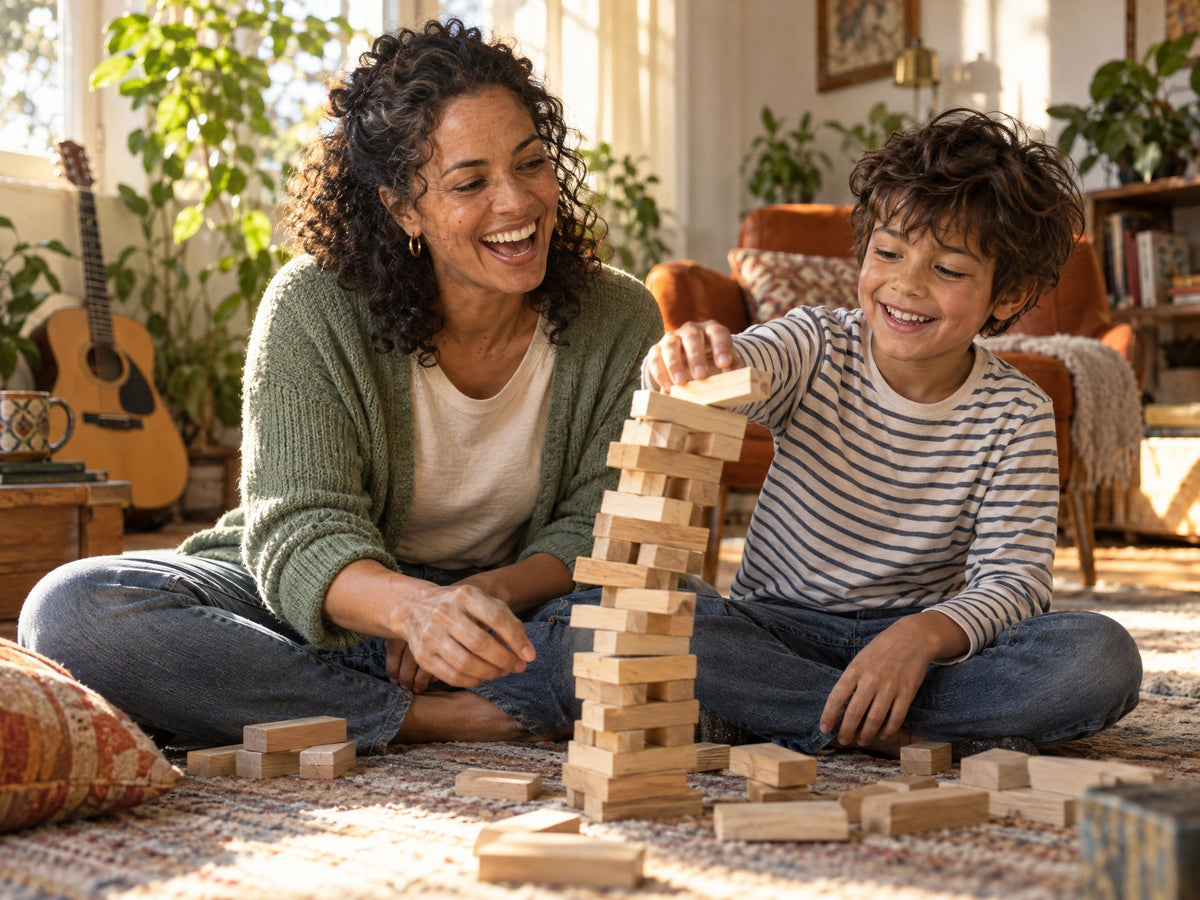 Woman laughing on the living room floor building a block tower with her son