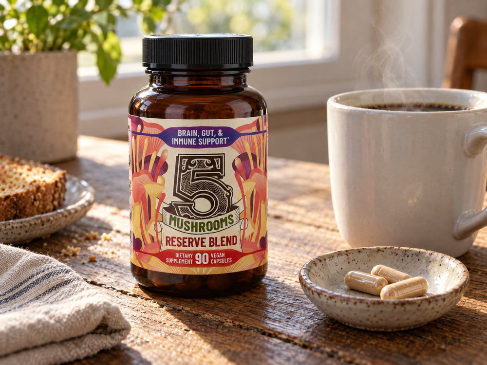 5 Mushrooms Reserve Blend bottle beside a mug of coffee and three capsules