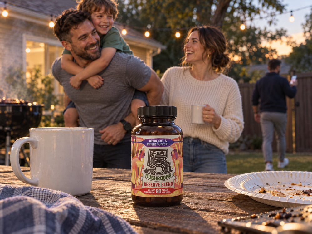 A bottle of 5 Mushrooms Reserve Blend on a backyard table while dad gives his son a piggyback ride