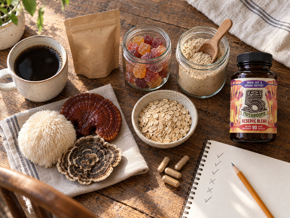 A kitchen table lineup of coffee, gummies, mushroom powder, oats, fresh mushrooms and a bottle of 5 Mushrooms Reserve Blend beside a checklist